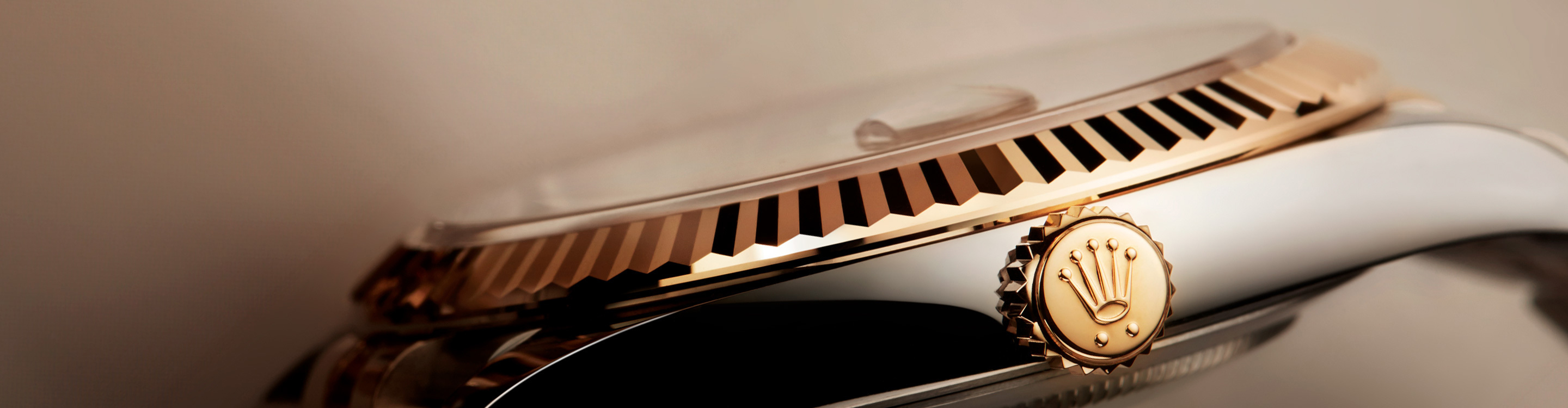 Rolex Datejust, highlighting fluted bezel and the crown. 