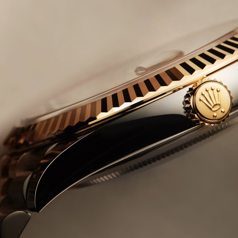 Rolex watch, highlighting fluted bezel and winding crown